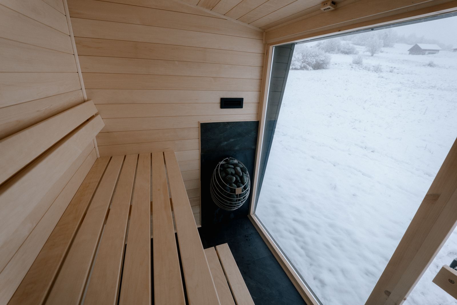 Sauna Kaizen interior view from above showing bench layout and panoramic window